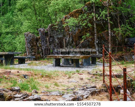 Picnic site stone table with benches on nature at path in Allmannajuvet area Sauda, Norway. Norwegian national tourist scenic route Ryfylke.