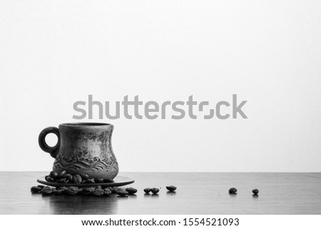 Arabian coffee cup and coffee beans. Free space for inscription. Black and white. 