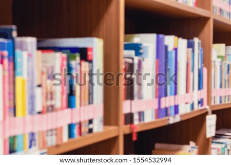 Picture of blur bookshelf as background in university or college library with copy space. Photo concept of education and knowledge. Blurry image.