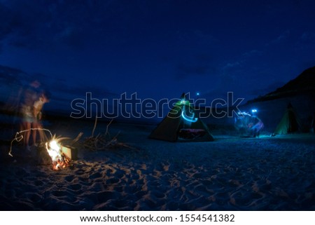 tent camp in desert sandy beach in baja california mexico at night