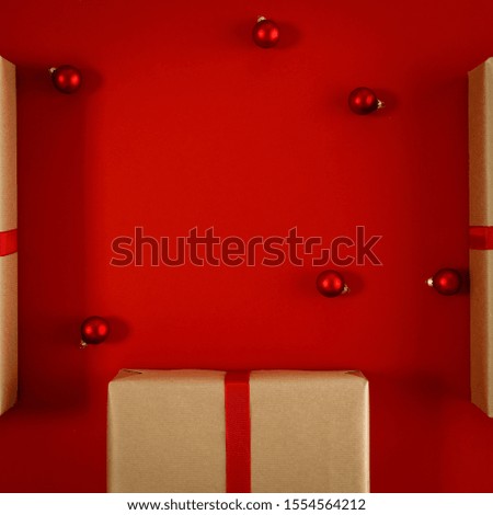 Christmas presents and red background.Gifts wrapped in ecological paper and ribbon with bow.Christmas time and winter december time.Place for your product slogan.Copy space,Flat lay,Top view