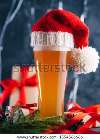 Christmas beer in a glass in Santa's hat