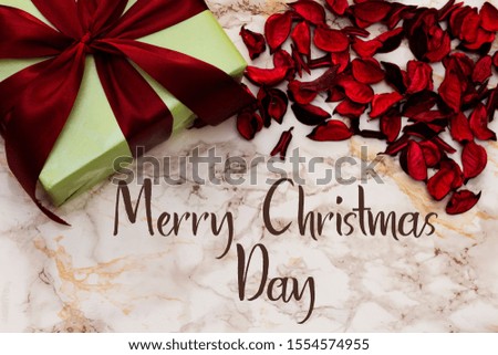  gift box with dried petals on marble background. merry christmas day 