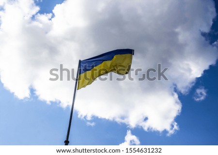 A Ukrainian flag in the blue sky