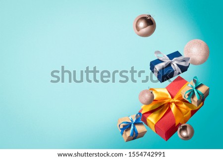 Flying gift boxes and Christmas decorations on a blue background. Holiday concept, christmas. Levitation. Items in the air. Flat lay, top view