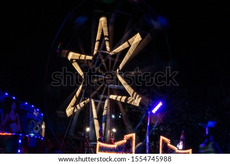 Long exposure of fairground Ferris wheel