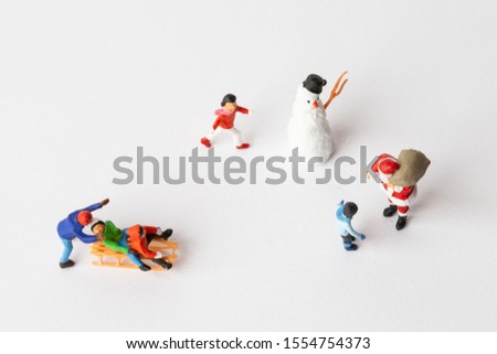 Miniature people: Santa Claus and kids playing fun. Christmas and Happy New Year concept.