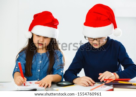 Happy little children in Santa hats on white background. Christmas celebration