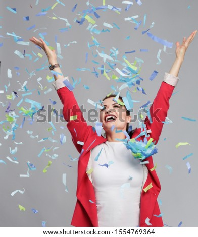 Portreit beautiful happy woman at celebration party with confetti .Birthday or New Year eve celebrating concept.