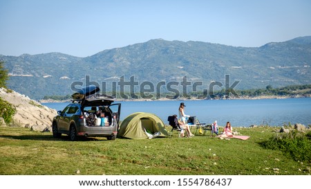Adventures Camping tourism and tent and car next to the lake. Landscape outdoor in morning, Serbia. Royalty-Free Stock Photo #1554786437
