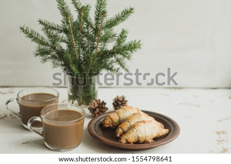 Christmas breakfast with coffee and croissants on a white background.