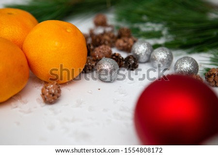 New Year and Christmas background.Fir branch and artificial snow along with Toys on white background.  