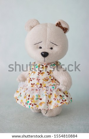 
Interior doll textile bear, white and brown bear, in a beautiful dress, a little gentle good friend.