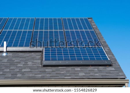 Tesla Solar Panels on Roof with Critter Guard Royalty-Free Stock Photo #1554826829