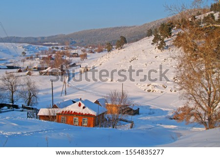 Winter landscape of a small village. Snow-white winter. Small neat houses in the snow.