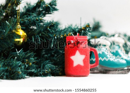Christmas candle and skates with Christmas tree isolated on white background. The object of the celebration with free space for text.