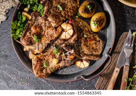 Delicious grilled meat seasoned with garlic and pepper, fresh salad