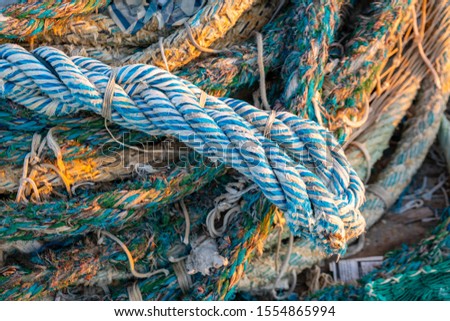 dirty old rope and nets for fishing on the dock Fiumicino. 