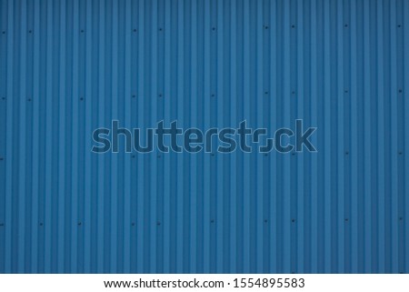 Blue background. Profiled metal. A beautiful fence. Texture