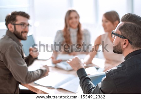 businessman looking at the handshake of business partners