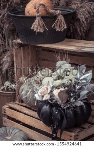 Beautiful autumn street decor with pumpkins and flowers. Autumn holiday and themed decorations.