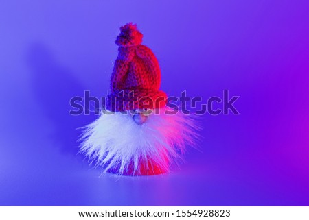 Modern conceptual art Santa with shadow in duotone pink and blue lights. Christmas decoration with copy space, greering card concept