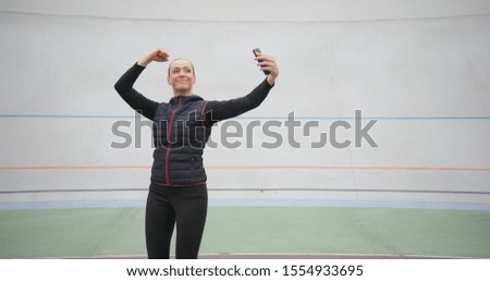 Funny picture of amusing slim fit woman on white background. Woman taking a selfie and making funny faces.