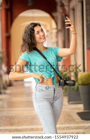 Girl tourist or professional photographer who shoots in a typical Italian city.