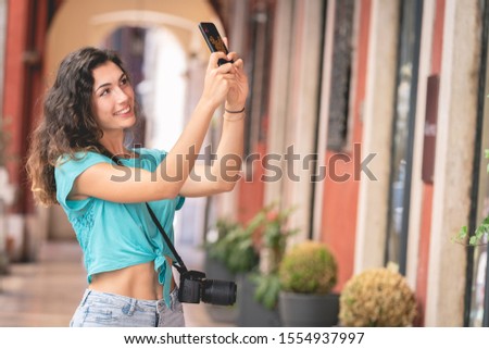 Girl tourist or professional photographer who shoots in a typical Italian city.