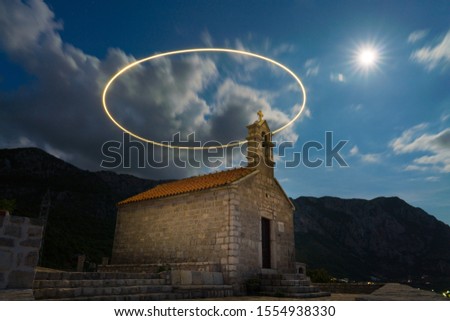 Saint Sava Church on Island Of Sveti Stefan with light-drawn circle at long exposure