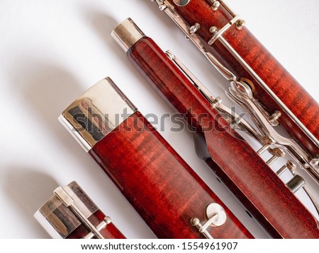 parts of a bassoon on the white background Royalty-Free Stock Photo #1554961907