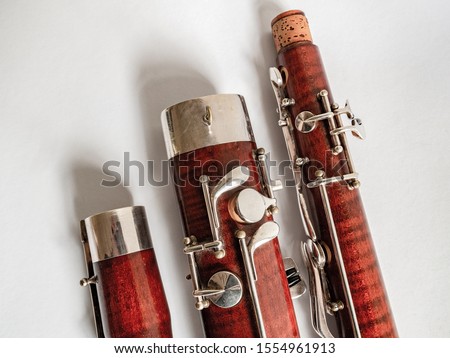 parts of a bassoon on the white background Royalty-Free Stock Photo #1554961913