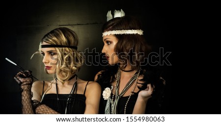 Roaring twenties poster flapper party girl, vintage 20s fashion style and make up and hairstyle, costume, model young woman, Caucasian girl Royalty-Free Stock Photo #1554980063