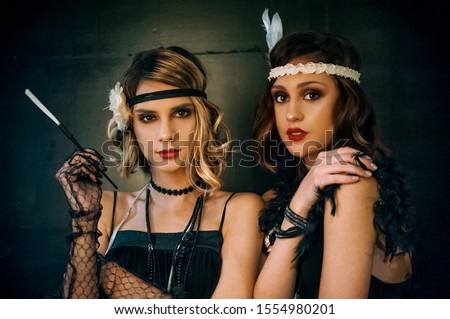 Roaring twenties poster flapper party girl, vintage 20s fashion style and make up and hairstyle, costume, model young woman, Caucasian girl Royalty-Free Stock Photo #1554980201