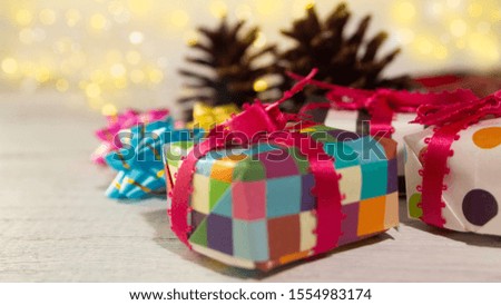 Christmas background: origami gifts and pine cones