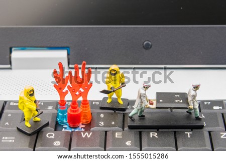Firefighters and rescue teams on keyboard computer laptop.Computer equipment.Computer repair concept
