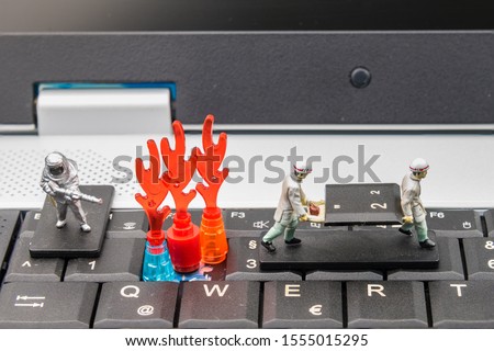 Firefighters and rescue teams on keyboard computer laptop.Computer equipment.Computer repair concept