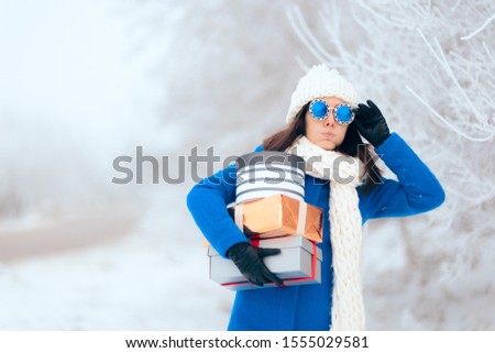 Tired Woman Carrying a Pile of Winter Christmas Gifts. Millennial feeling the pressure of the stressful winter holidays
