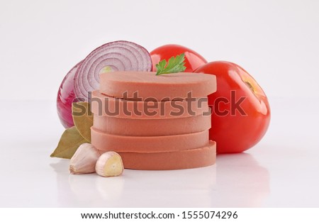 luncheon canned meat cuts, cold cuts, slices with vegetables on white background Royalty-Free Stock Photo #1555074296