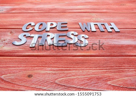 steel letters lie on a wooden texture Board, the color of living coral, suitable for advertising resistance courses, or biological additives to food