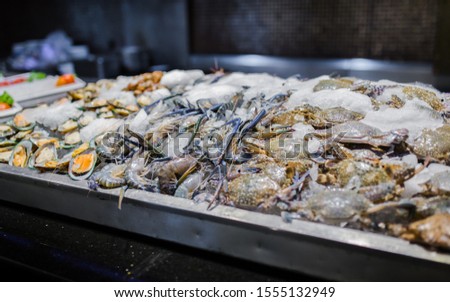 Picture of fresh green mussel, prawns and crab in seafood on ice buffet bar