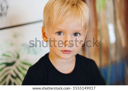 Cute Smiling Boy With Blonde Hair And Green Eyes Isolated On
