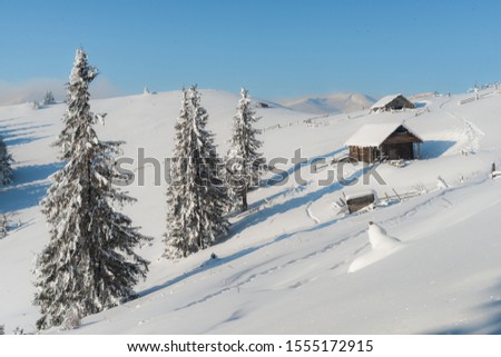 Beautiful pictures of nature in winter. Landscape with mountain huts in the snow. 