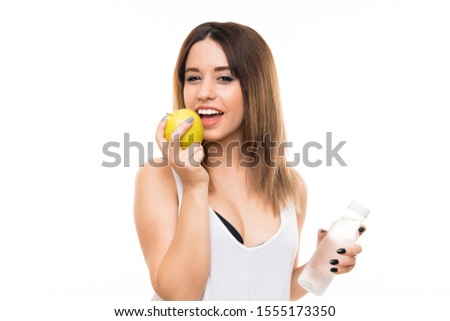 Young woman over isolated white background with an apple