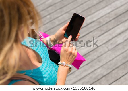 Woman using smartphone, view from above