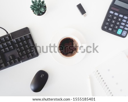 top view of office desk table with coffee cup, keyboard and notebook on white background, graphic designer, Creative Designer concept.