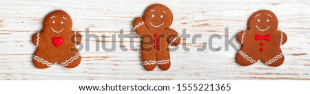 Gingerbread. Traditional new Year and Christmas treats. Cookies in the form of merry men. The concept of the celebration. Holidays. Top view, selective focus, copy space, long picture, banner