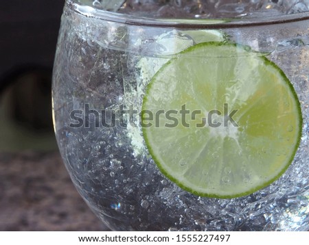 Refreshing soda tonic fizzy water, lime in Glass, ice.Slice of lemon, mineral bubbles. Detox or thirst concept Healthy, dietary nutrition, Close up 