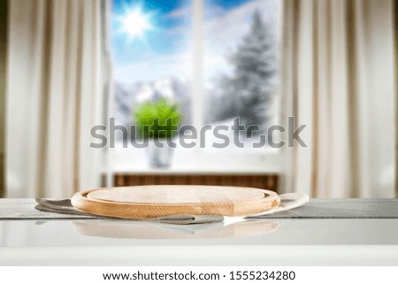 Table background of free space and blurred home interior. 