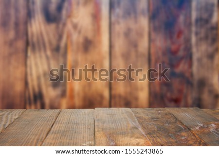 Empty old Dark wooden rustic table top made of planks with uneven edges on grunge rustic vintage dark textured wooden background. Using as background montage concept with copy spaces and white space